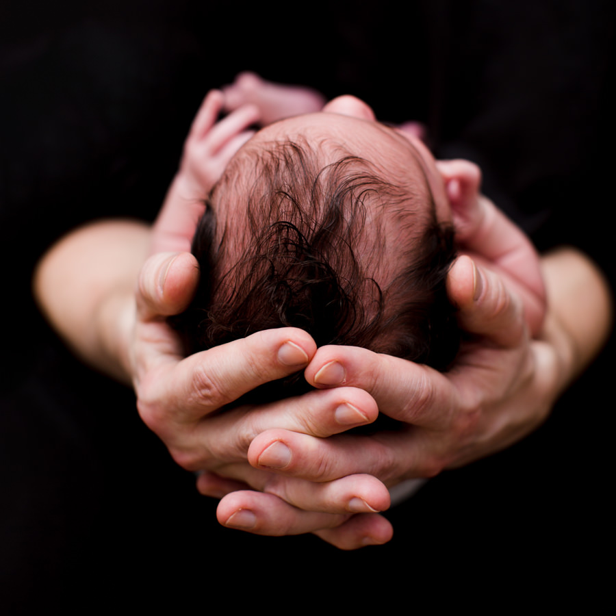 Newborn in fathers hand